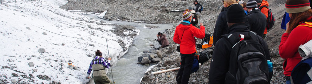 Students on glacial runoff in Greenland